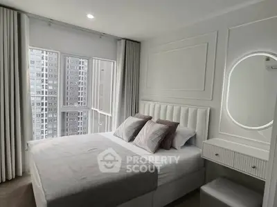 Modern bedroom with elegant decor and large window view in urban apartment