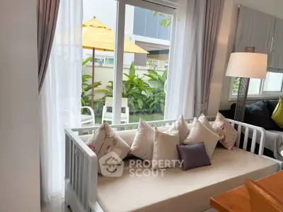 Charming living room with cozy seating and garden view, perfect for relaxation.