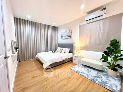 Spacious modern bedroom with elegant decor and cozy ambiance, featuring a stylish bed and ambient lighting.