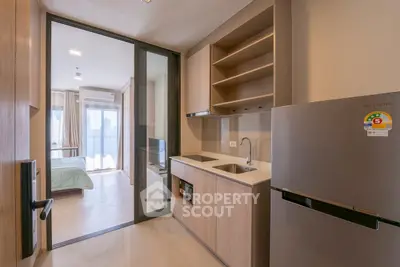 Modern studio apartment with sleek kitchen and cozy bedroom