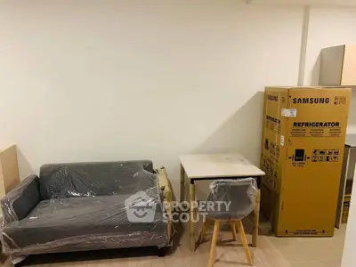 Modern apartment interior with new furniture and Samsung refrigerator box.
