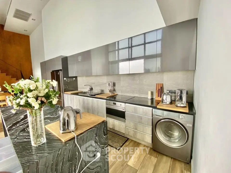 Modern kitchen with sleek cabinetry and built-in appliances in a stylish open layout.