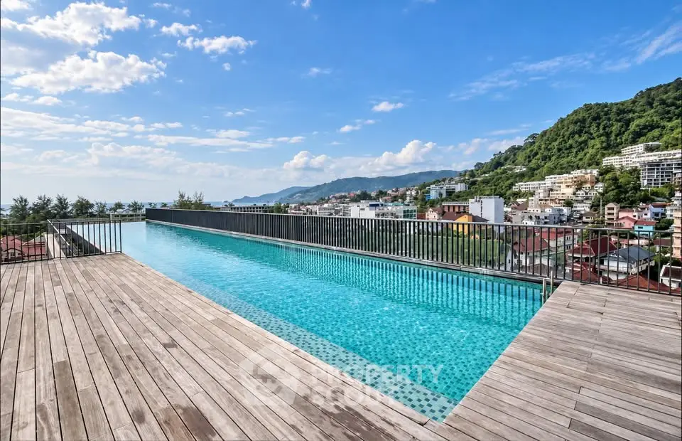 Stunning rooftop infinity pool with panoramic city and mountain views.