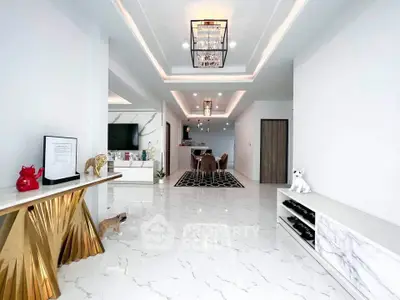 Luxurious modern living room with elegant decor and marble flooring, featuring a stylish chandelier and open layout.
