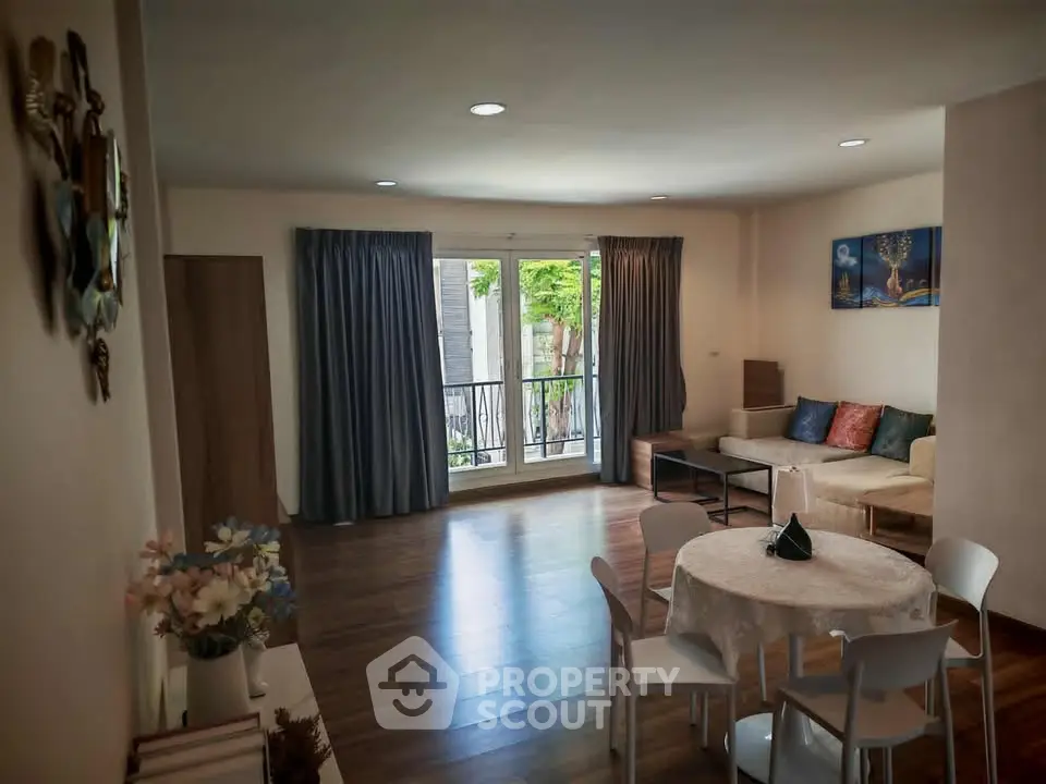 Spacious living room with modern decor and large window for natural light.