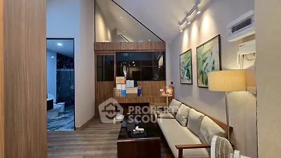 Modern living room with elegant decor and adjacent bathroom view
