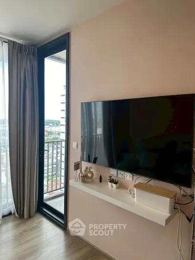 Modern living room with wall-mounted TV and balcony view