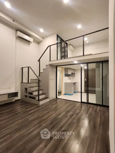 Modern loft apartment with mezzanine and sleek wooden flooring