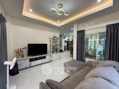 Modern living room with elegant ceiling lights and cozy gray sofa