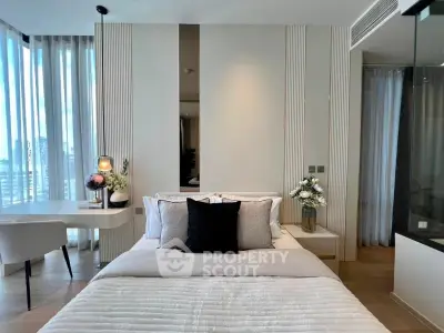 Luxurious modern bedroom with elegant decor and natural light, featuring a cozy bed and stylish desk area.