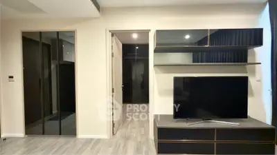 Modern living room with sleek TV unit and mirrored closet doors