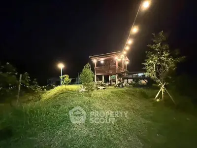 Charming rustic cabin with outdoor lighting in a serene nighttime setting, perfect for nature lovers.
