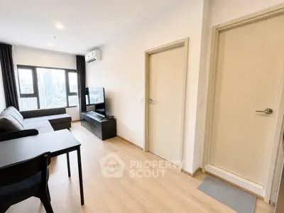 Modern living room with city view, featuring sleek furniture and natural light.