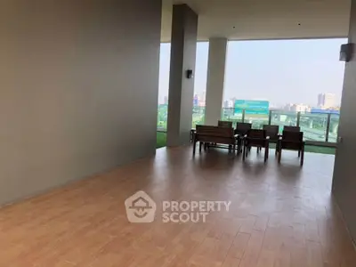 Spacious balcony with city view and outdoor seating in modern apartment