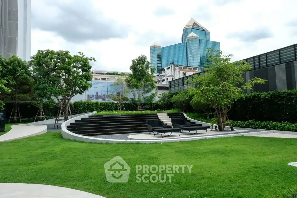 Modern urban garden with seating area and city skyline view