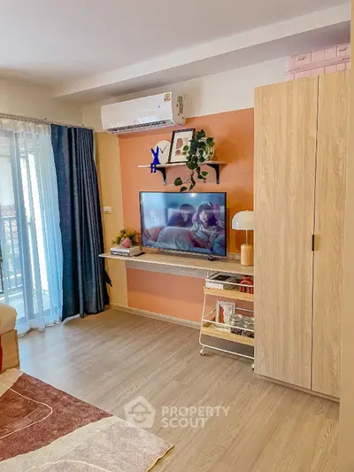 Cozy living room with TV, air conditioning, and modern decor