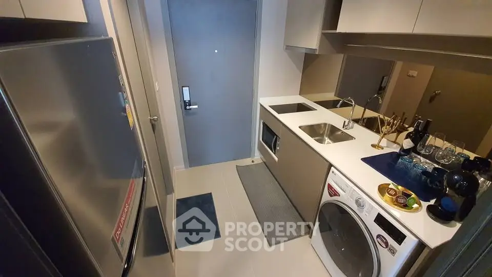 Modern compact kitchen with sleek appliances and stylish decor
