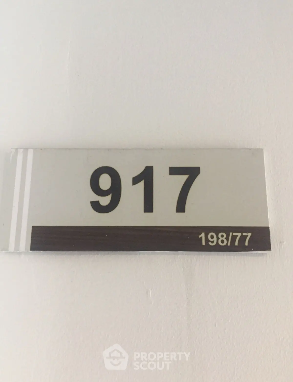Room number 917 sign on a white wall in a building.