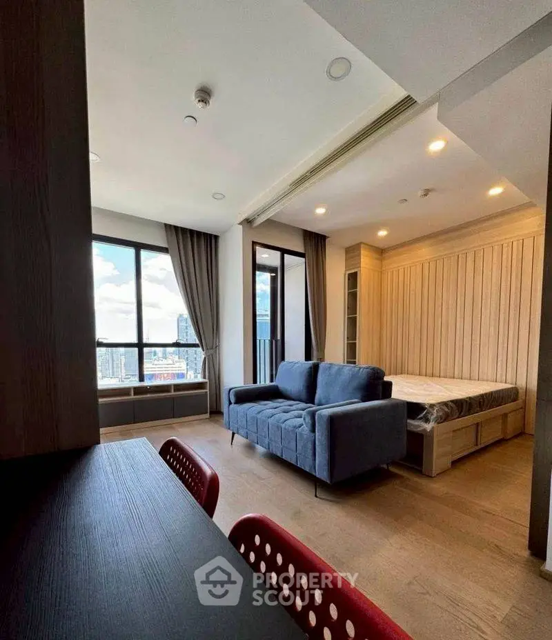 Modern studio apartment with cozy living area and city view