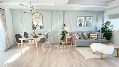 Stylish living room with modern decor, cozy seating, and elegant dining area in bright, airy space.