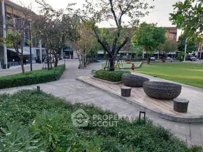 Charming garden area with modern seating and lush greenery, perfect for relaxation and outdoor activities.