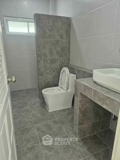 Modern bathroom with sleek gray tiles and contemporary fixtures