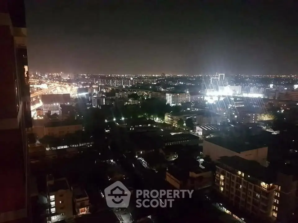 Stunning nighttime cityscape view from high-rise apartment balcony