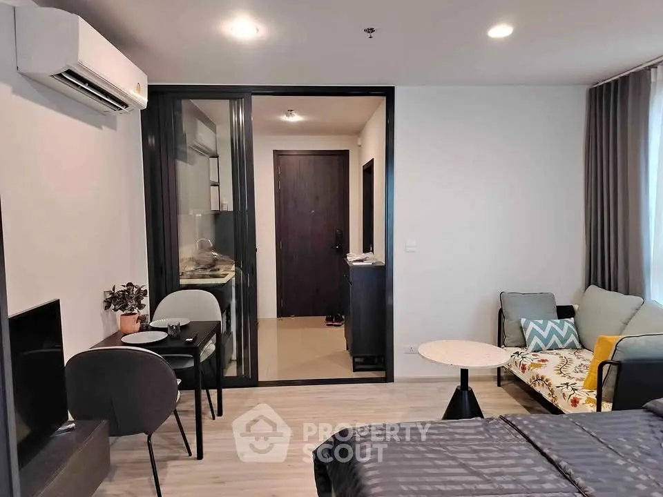 Modern studio apartment with open layout, featuring cozy living area and stylish decor.