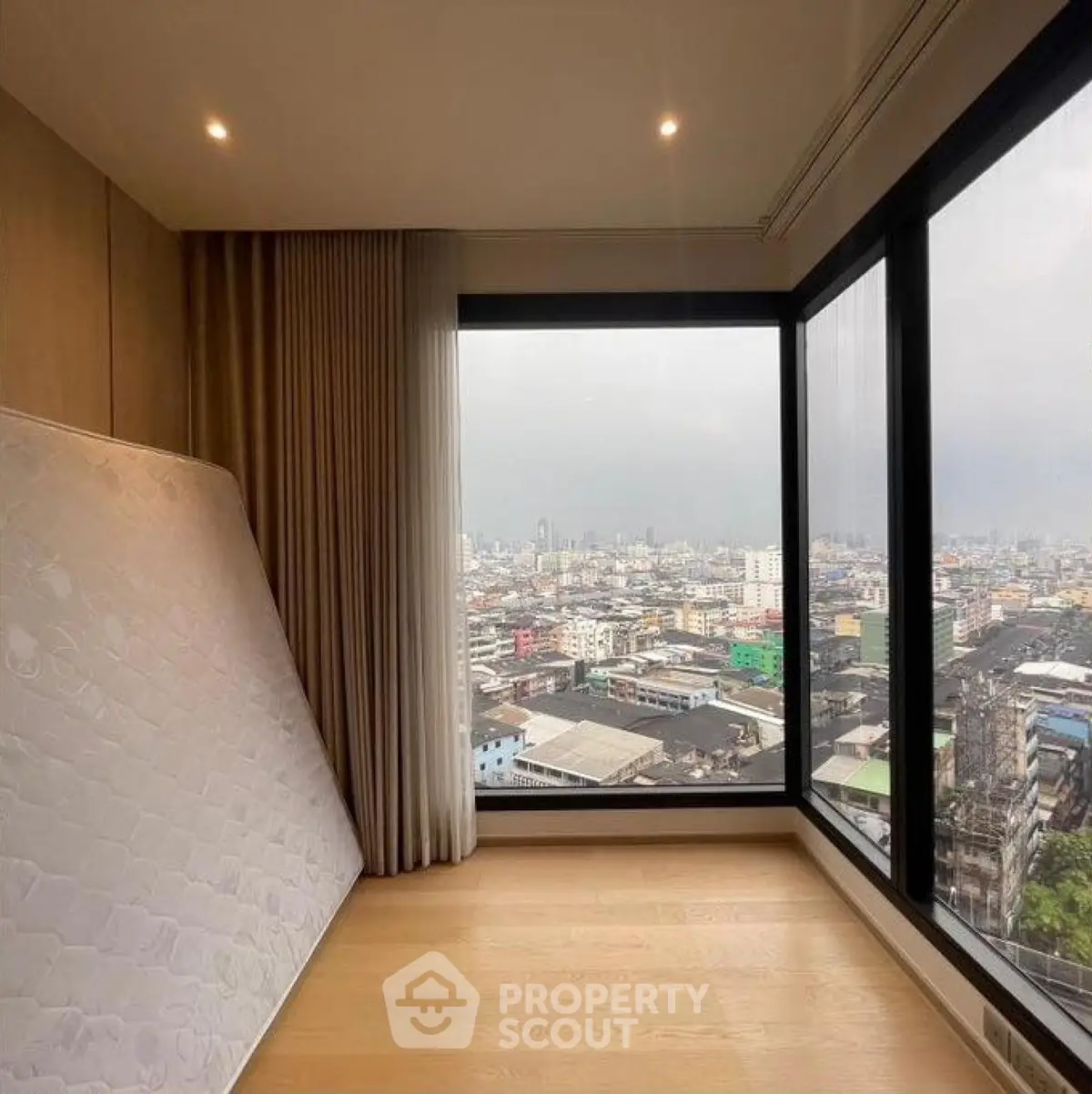 Spacious corner unit with panoramic city view and large windows, perfect for urban living.