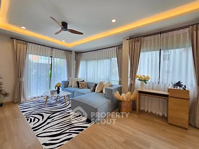 Stylish living room with modern decor and large windows for natural light.