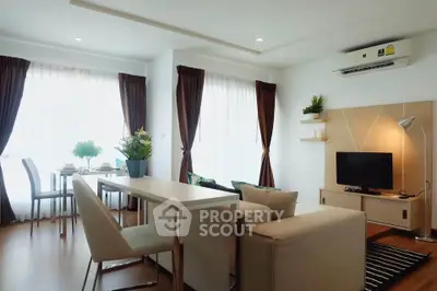 Modern living room with dining area, featuring sleek furniture and abundant natural light.