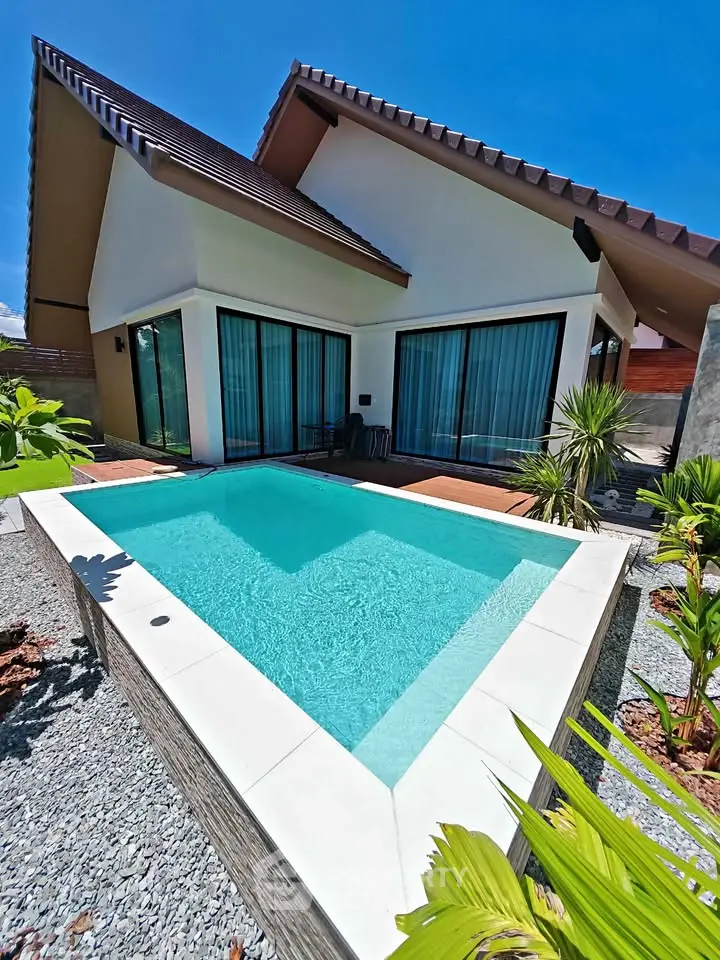 Luxurious modern villa with private pool and lush garden in tropical paradise.