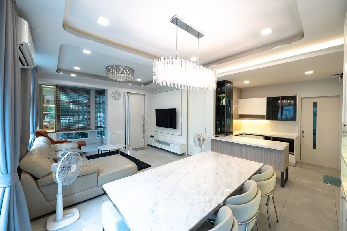 Luxurious open-plan living room and kitchen with modern decor and elegant lighting