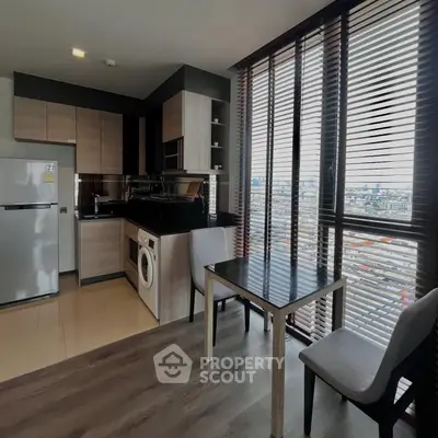 Modern kitchen with open layout and city view, featuring sleek appliances and stylish dining area.