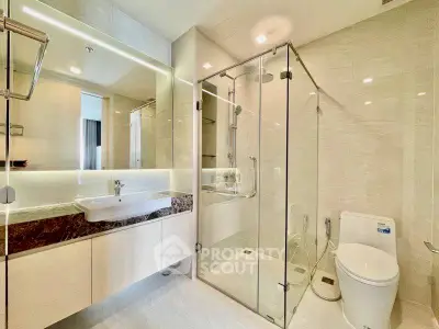 Luxurious modern bathroom with glass shower and elegant fixtures