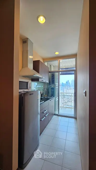 Modern kitchen with city view and sleek appliances in high-rise apartment