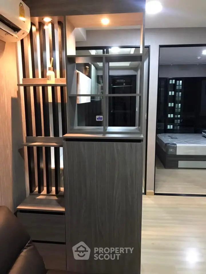 Modern apartment interior with stylish wooden partition and cozy bedroom view.
