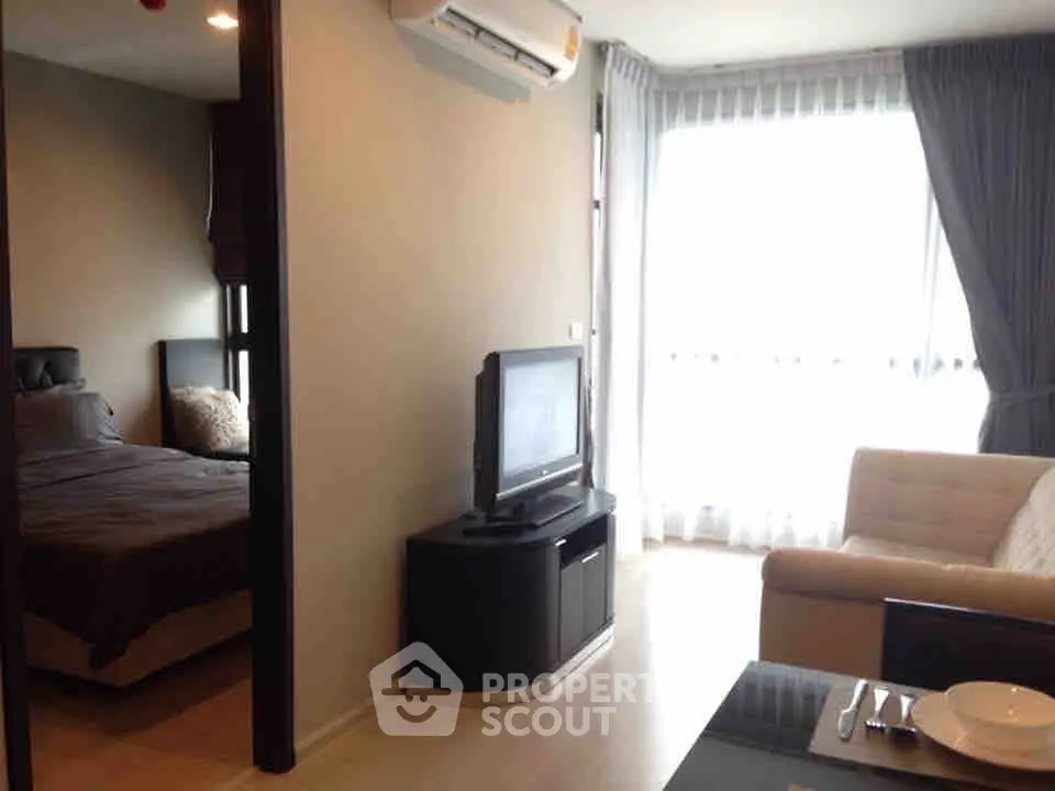 Modern apartment interior with cozy living room and bedroom, featuring natural light and stylish furnishings.