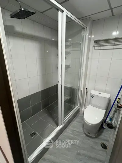 Modern bathroom with sleek shower enclosure and tiled walls
