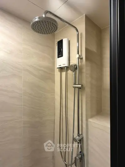 Modern bathroom with sleek showerhead and water heater, featuring elegant beige tiles for a luxurious feel.