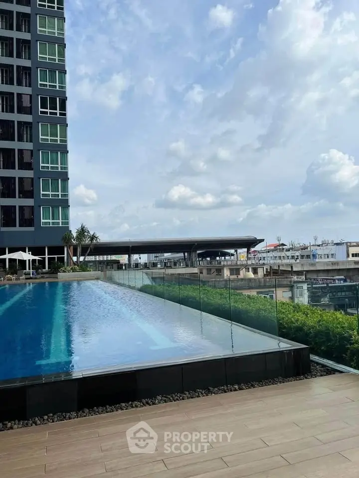 Luxurious high-rise building with stunning rooftop infinity pool and panoramic city views.