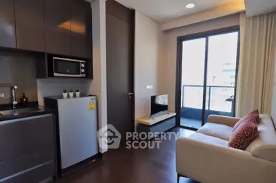 Modern compact living room with kitchenette and balcony view