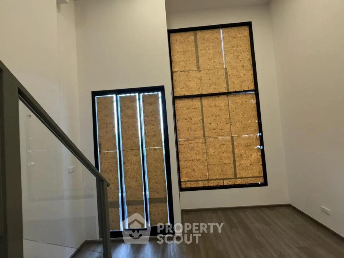 Modern interior with large windows and sleek staircase in minimalist design