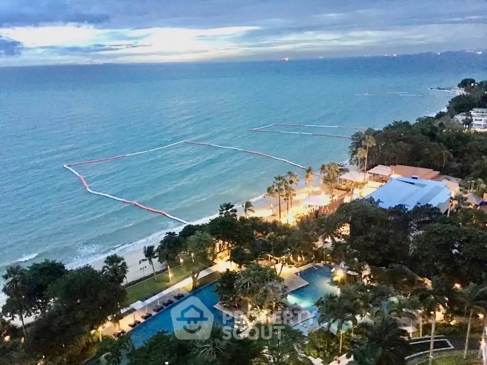 Stunning beachfront view with pool and lush greenery at luxury resort