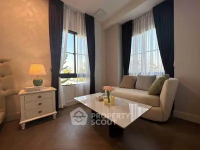Elegant living room with stylish decor and natural light, featuring a cozy sofa and chic coffee table.