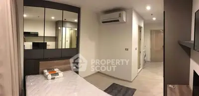 Modern bedroom with sleek design and built-in storage in a contemporary apartment.