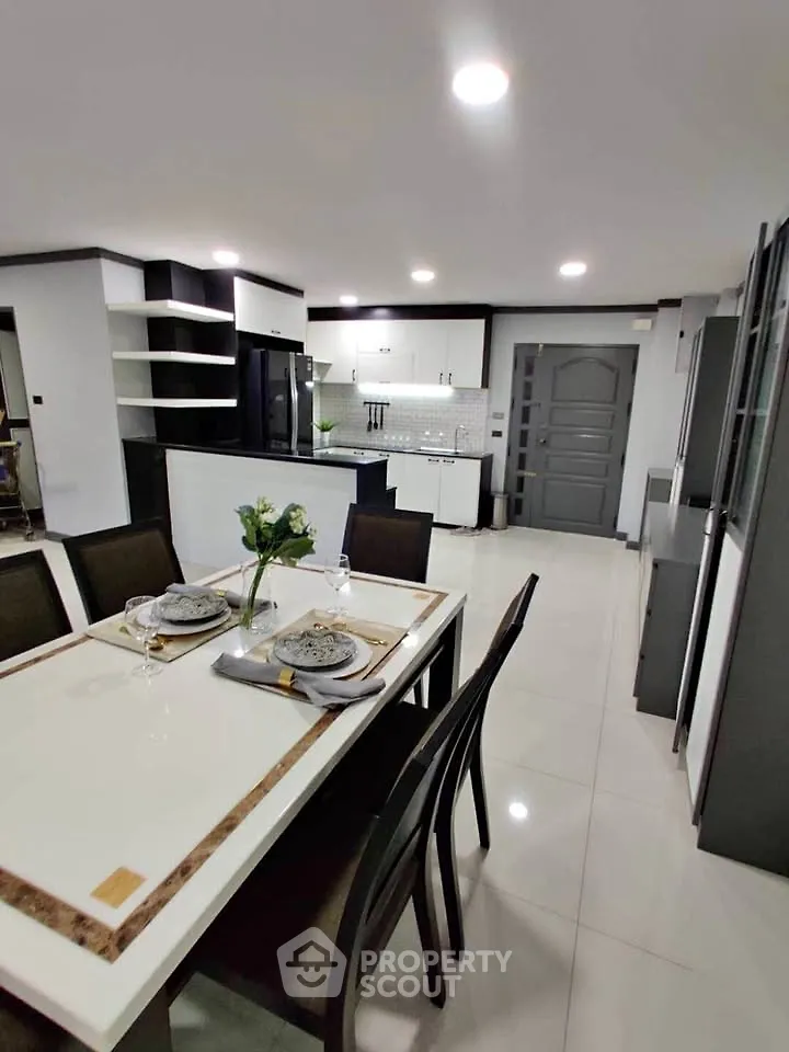 Modern kitchen and dining area with sleek design and elegant decor.