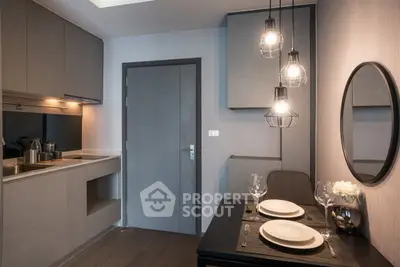 Modern kitchen with sleek cabinetry and stylish dining area in a contemporary apartment.