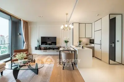 Modern open-plan living room and kitchen with elegant decor and city view.