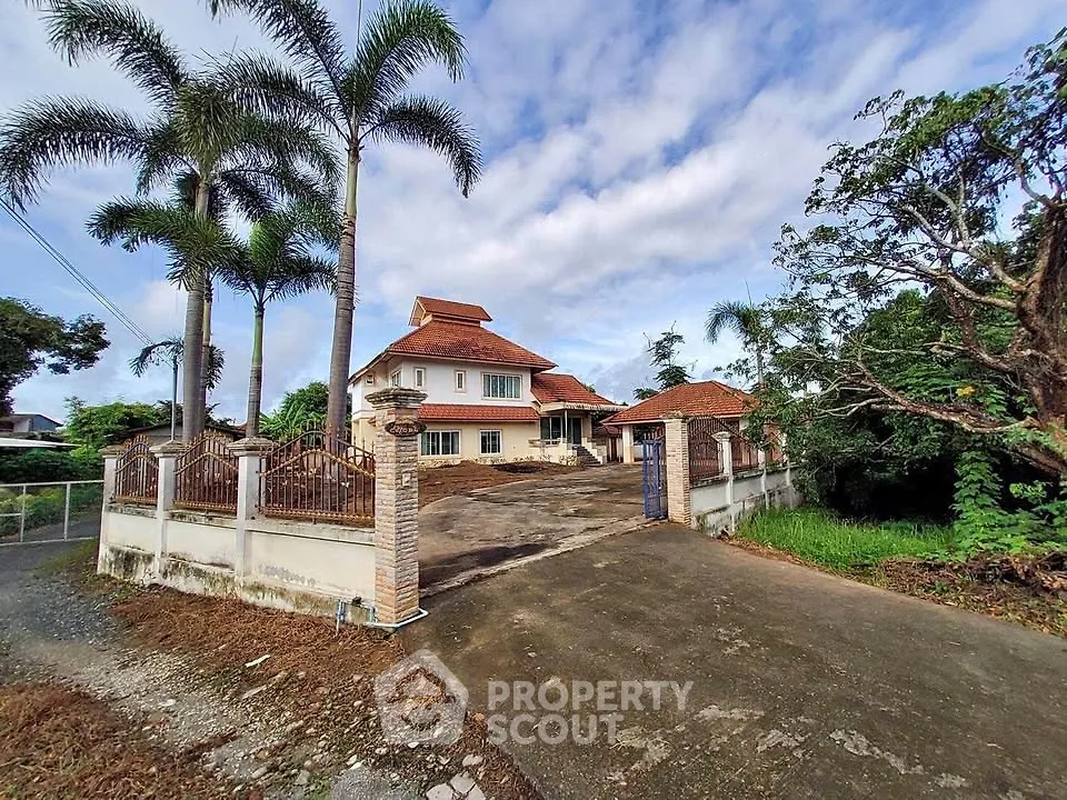 Charming suburban house with spacious driveway and lush greenery, perfect for family living.